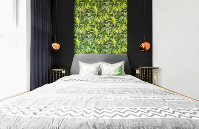 a bedroom with a large white bed with a green wall at Downtown - Netflix - AC - Next to Metro and Train in Sofia