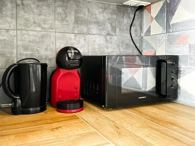 a microwave and a coffee maker on the floor at Downtown - Netflix - AC - Next to Metro and Train in Sofia