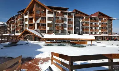 a resort in the snow with a large building at Bansko Belvedere Apartments in Bansko