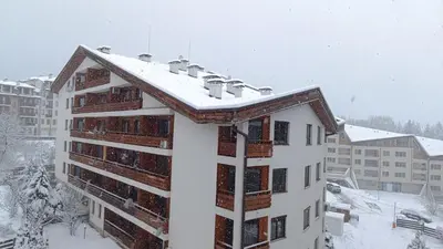 a building with snow on top of it at Studio Detelina Residence in Bansko