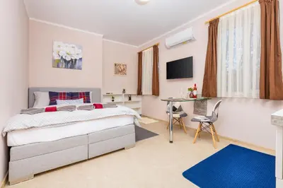 a bedroom with a bed and a desk and a table at Stella 1&2 - Pink and Grey Studios near the Singing Fountains by Flat Mаnager in Plovdiv