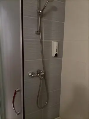 a shower in a bathroom with a glass door at Belvedere Holiday Club 101 in Bansko