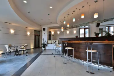 a bar in a restaurant with chairs and tables at Bellevue Residence RELAX ZONE in Bansko