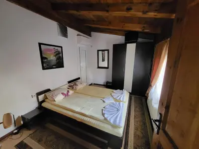 a small bedroom with a bed in a room at Oasis Guest House in Dobrinishte
