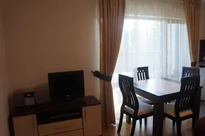 a room with a table and chairs and a window at Pamporovo Central Apartments in Pamporovo
