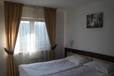 a bedroom with a bed and a window at Pamporovo Central Apartments in Pamporovo