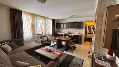 a living room with a couch and a table at Top of the Mountain Гранд Манастира частни Апартаменти in Pamporovo