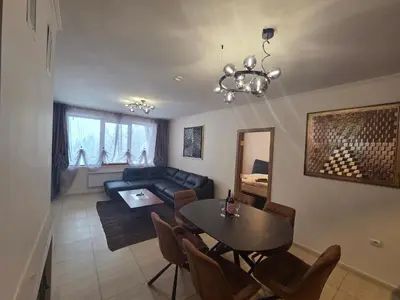 a living room with a table and a couch at Top of the Mountain Гранд Манастира частни Апартаменти in Pamporovo