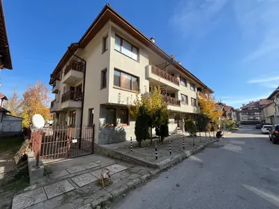a large building on the side of a street at MH Apartments in Bansko