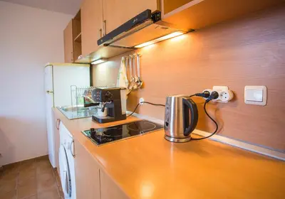 a kitchen with a counter with a coffee maker on it at Cozy Colorful Studio at the foot of the Mountain by Flat Mаnager in Bansko