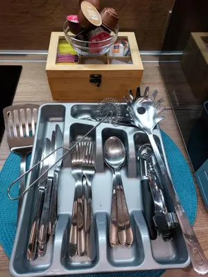 a tray of silver utensils on a table at MAGRI Luxurious Apartment A42 Borovets Gardens in Borovets