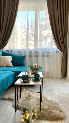 a living room with a blue couch and a table at MAGRI Luxurious Apartment A42 Borovets Gardens in Borovets