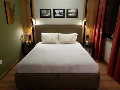 a bedroom with a large bed with two pillows at Pinewood ANG luxurious apartment A32 in Borovets