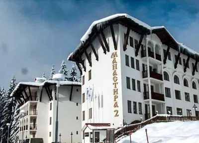 a hotel with snow on top of it at Луксозен Апартамент Мечи Чал - Апартхотел Манастира 2 in Pamporovo