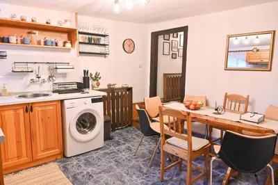 a kitchen with a table and a washing machine at 4 BDR House Monument of Culture & Architecture by Flat Mаnаger in Bansko