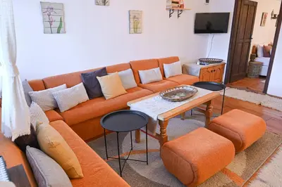 a living room with a couch and a table at 4 BDR House Monument of Culture & Architecture by Flat Mаnаger in Bansko