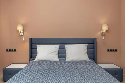 a bedroom with a blue bed with two pillows at ~Angels ~ Two-Bedroom Deluxe Flat in City Centre in Sofia