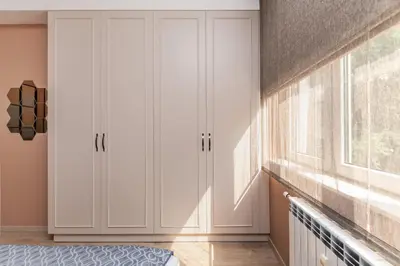 a bedroom with white cabinets and a window at ~Angels ~ Two-Bedroom Deluxe Flat in City Centre in Sofia