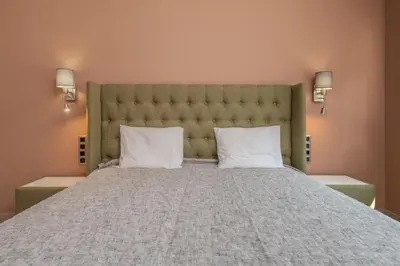 a bedroom with a large bed with two pillows at ~Angels ~ Two-Bedroom Deluxe Flat in City Centre in Sofia