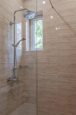 a shower with a glass door in a bathroom at ~Angels ~ Two-Bedroom Deluxe Flat in City Centre in Sofia