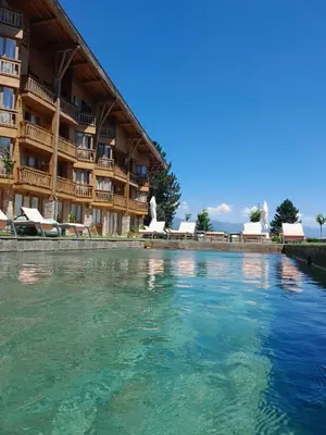 a swimming pool in front of a resort at Rustic Spa at Pirin Golf in Razlog