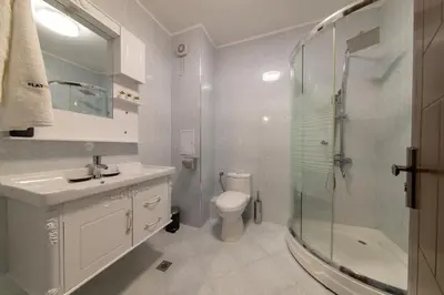 a bathroom with a toilet and a sink and a shower at Colors of Nature in Stylish Flat in Pamporovo by Flat Mаnager in Pamporovo