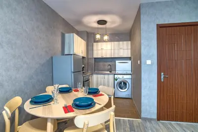 a kitchen with a table with blue plates on it at Colors of Nature in Stylish Flat in Pamporovo by Flat Mаnager in Pamporovo