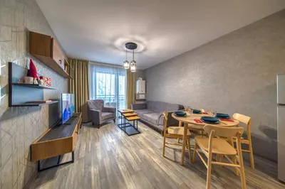 a living room with a couch and a table and chairs at Colors of Nature in Stylish Flat in Pamporovo by Flat Mаnager in Pamporovo