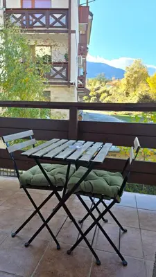 a bench sitting on top of a balcony at Bansko Boutique Apartments - Flora Boutique in Bansko