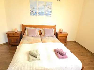 a bedroom with a bed with two towels on it at Bansko Boutique Apartments - Flora Boutique in Bansko
