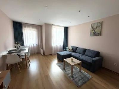 a living room with a blue couch and a table at Apartment in Studenets, Pamporovo in Pamporovo