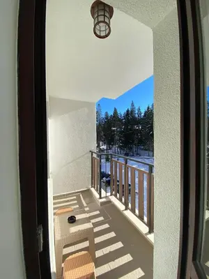 a view from the balcony of a house at Borovets Gardens Ski Apartment in Borovets