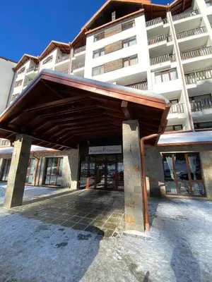 a building with awning in front of a building at Borovets Gardens Ski Apartment in Borovets