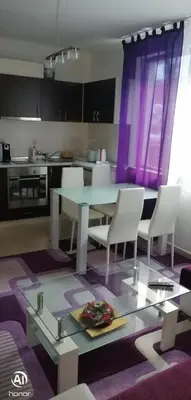 a kitchen with a glass table and white chairs at Ski Place in Pamporovo