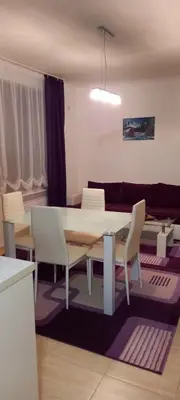 a living room with a table and chairs and a couch at Ski Place in Pamporovo