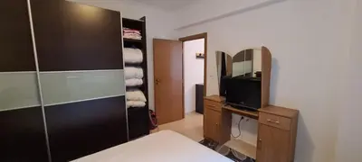 a bedroom with a bed and a tv and a mirror at Ski Place in Pamporovo