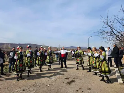 a group of people in folk costumes walking down a road at Винарна-Славовица in Kalugerovo