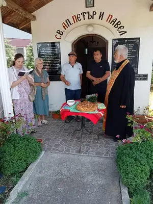 a group of people standing around a table with a cake at Винарна-Славовица in Kalugerovo