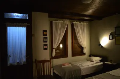 a bedroom with two beds and a window at Yakusha - Якуша, къща за гости in Shiroka Lŭka