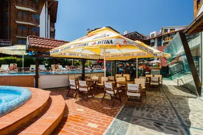 a restaurant with tables and chairs and a swimming pool at Belvedere luxury apartment in Bansko