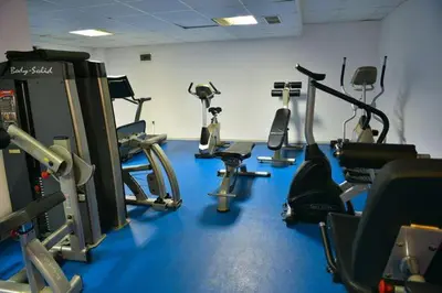 a gym with several cardio machines in a room at Belvedere luxury apartment in Bansko