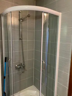 a shower with a glass door in a bathroom at Belvedere luxury apartment in Bansko