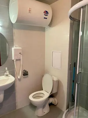 a bathroom with a toilet and a sink and a shower at Belvedere luxury apartment in Bansko