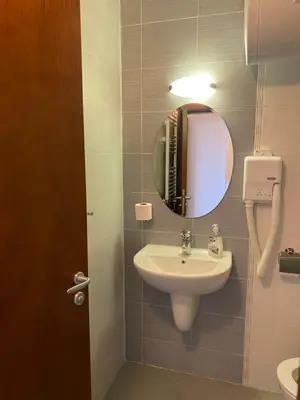 a bathroom with a sink and a mirror at Belvedere luxury apartment in Bansko