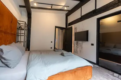 a bedroom with a bed and a flat screen tv at Bashtin Dom - Skabrin House in Bansko
