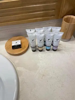 a group of four cups sitting on a bathroom counter at Pirin Golf Villa in Bansko