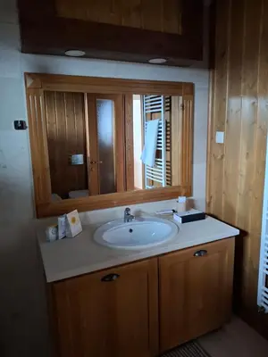 a bathroom with a sink and a mirror at Pirin Golf Villa in Bansko