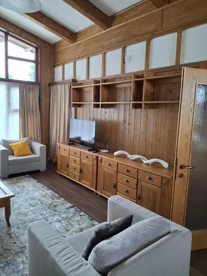 a living room with a couch and a tv at Pirin Golf Villa in Bansko