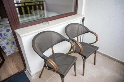 a pair of chairs sitting next to a window at All Seasons Apartments Borovets Gardens in Borovets