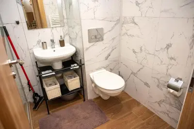 a bathroom with a toilet and a sink at All Seasons Apartments Borovets Gardens in Borovets